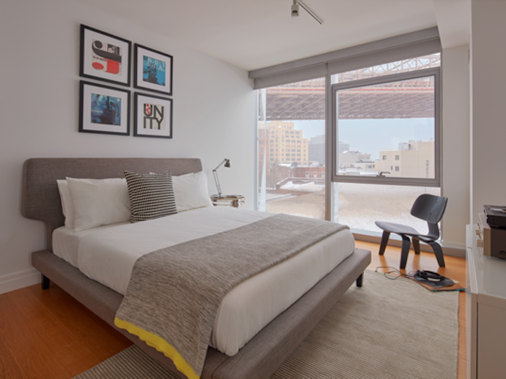 a bedroom with a bed and desk in a room
