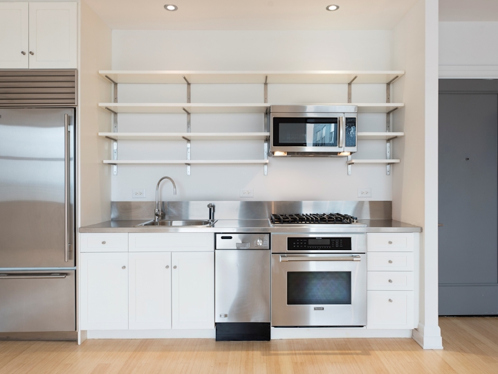 a white refrigerator freezer sitting inside of a kitchen
