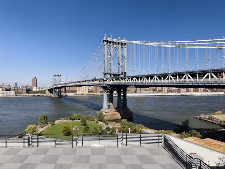 a train crossing a bridge over a body of water