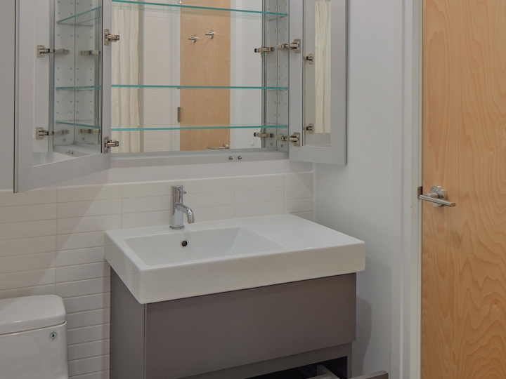 a room with a sink and a mirror