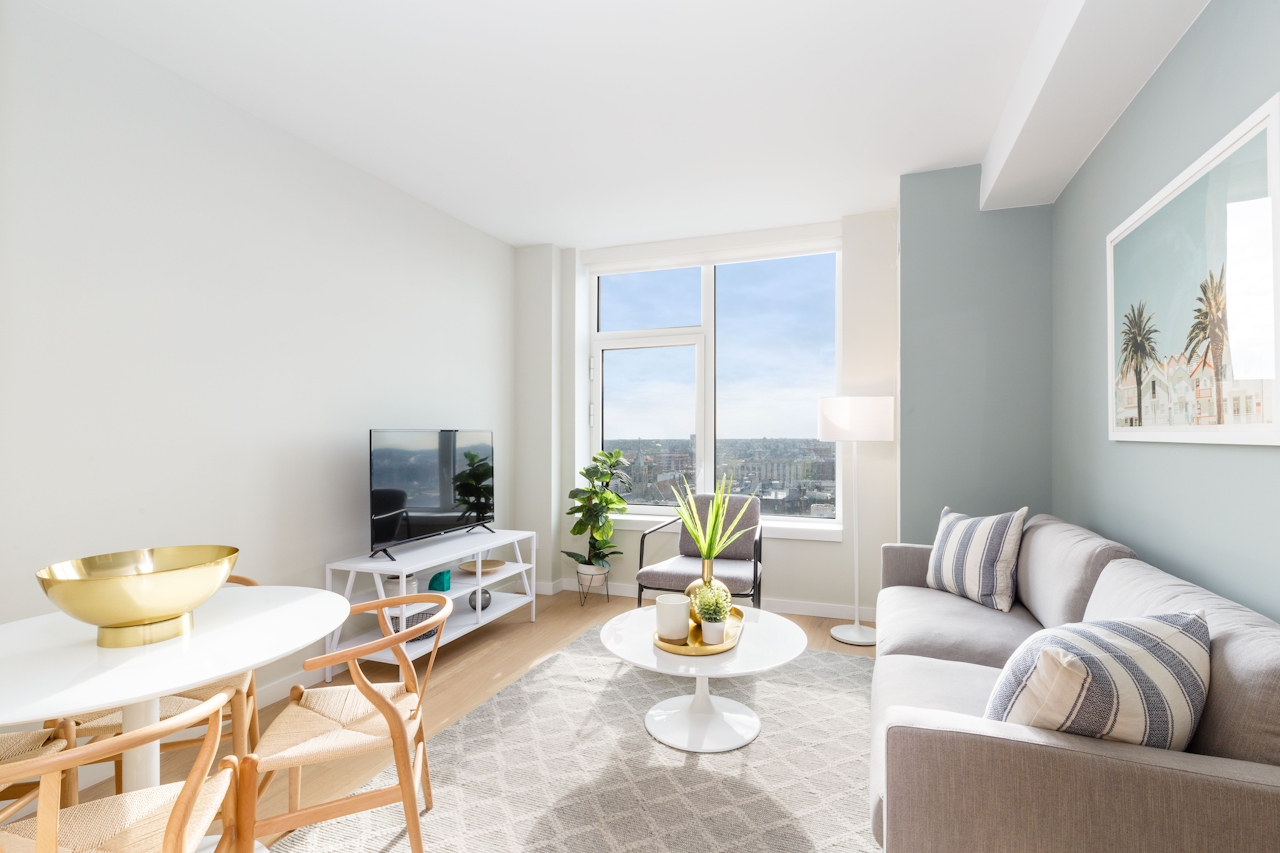 a living room filled with furniture and a large window