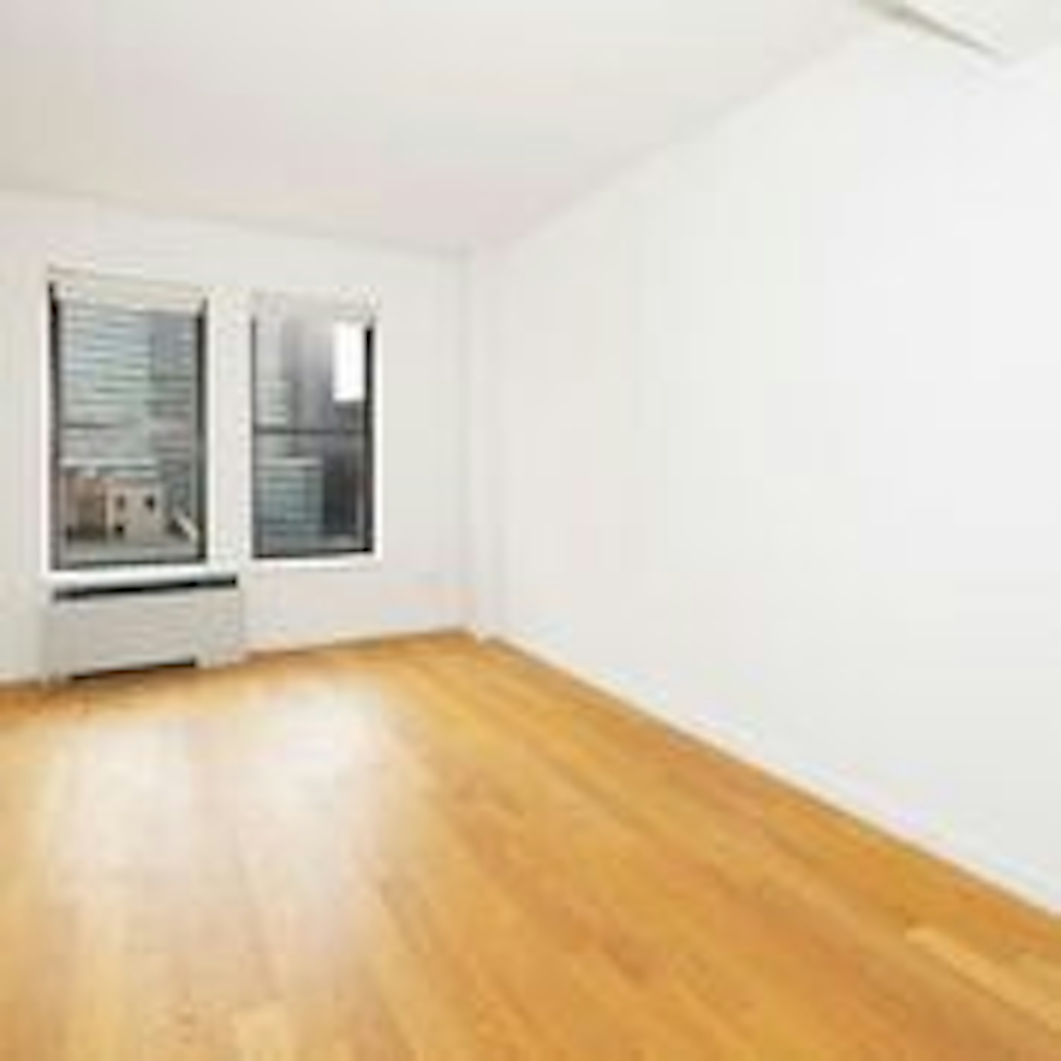 a large empty room with a hard wood floor