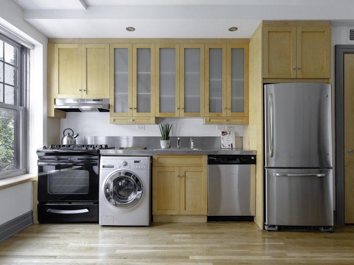 a kitchen with white appliances and wooden cabinets