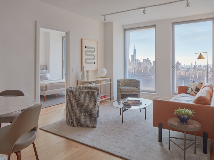 a living room filled with furniture and a large window