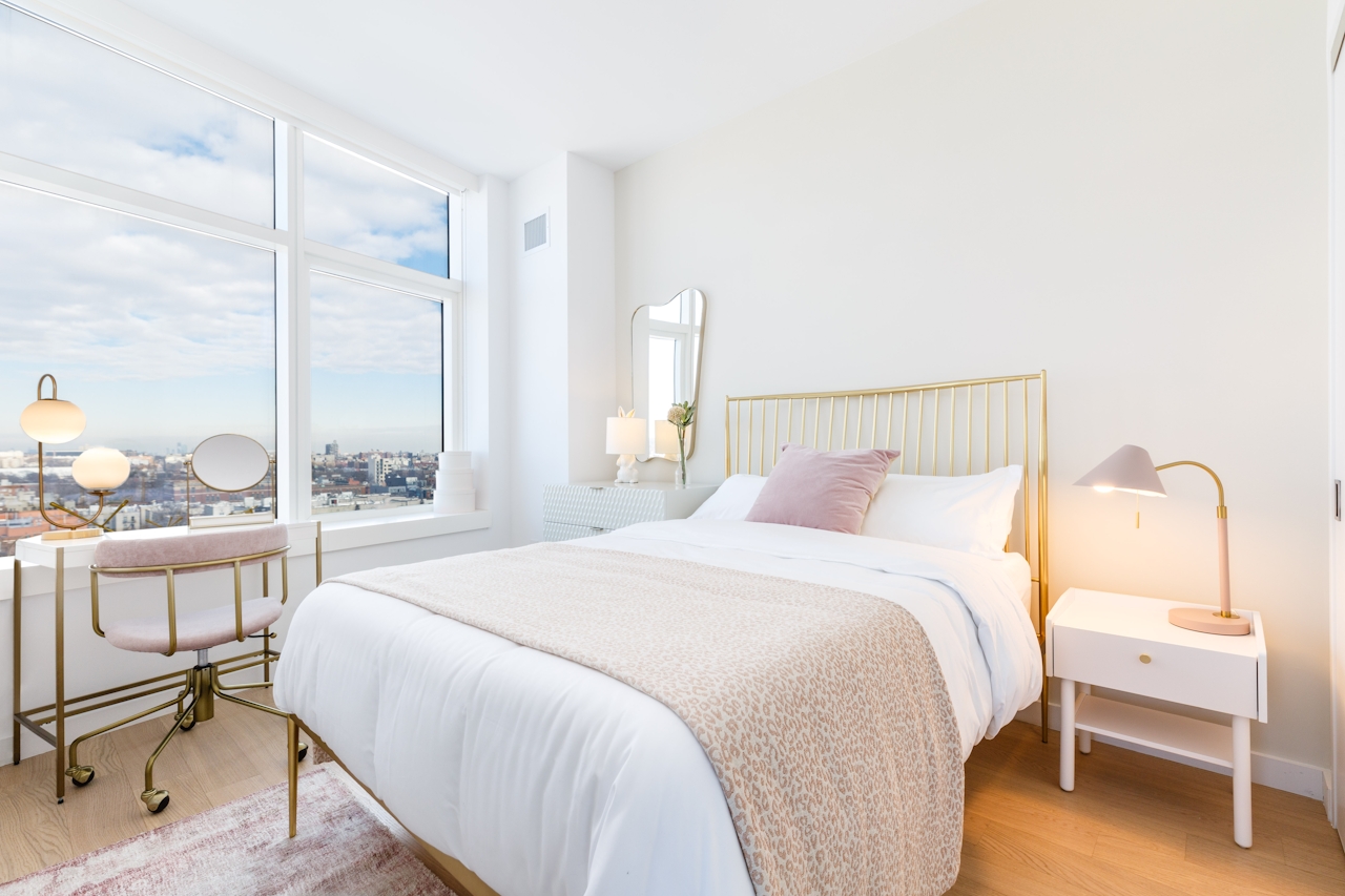 a bedroom with a bed and desk in a hotel room
