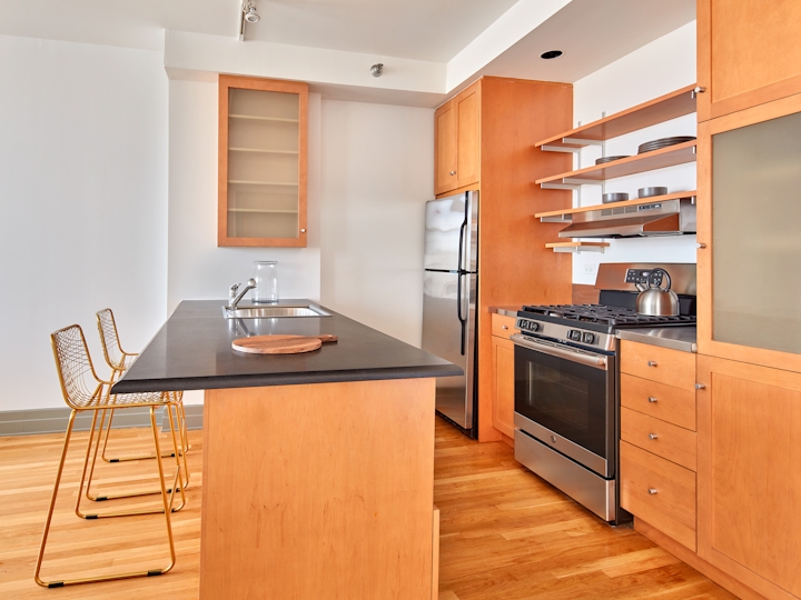 a kitchen with wooden cabinets in a room