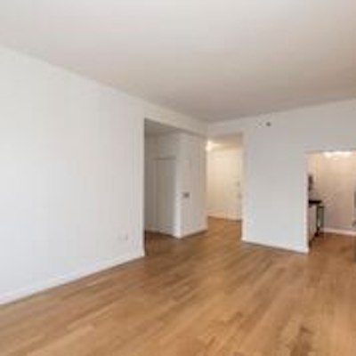 a large empty room with a wood floor