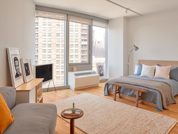 a bedroom with a bed and a chair in a room