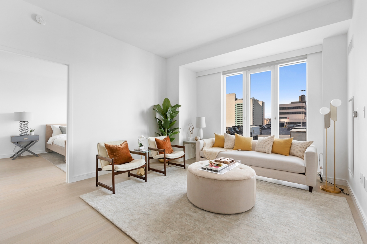 a living room filled with furniture and a large window