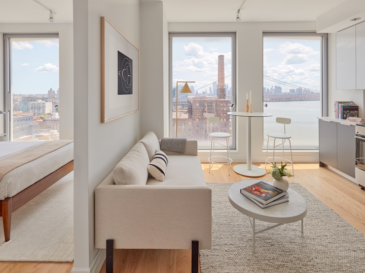 a view of a living room filled with furniture and a large window