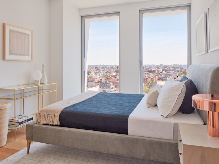 a bedroom with a bed and a chair in a room