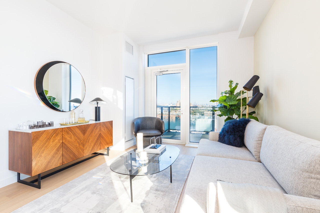 a living room filled with furniture and a large window