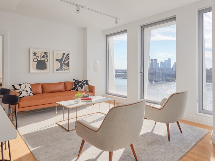a living room filled with furniture and a large window