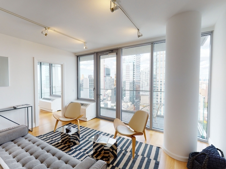 a living room filled with furniture and a large window