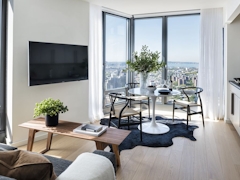 Thumbnail of The Ashland: 39J a living room filled with furniture and a large window