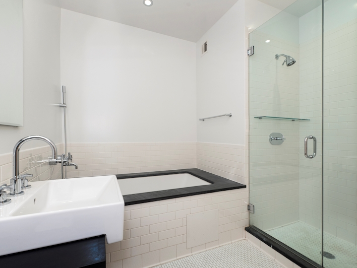 a white sink sitting next to a glass shower door