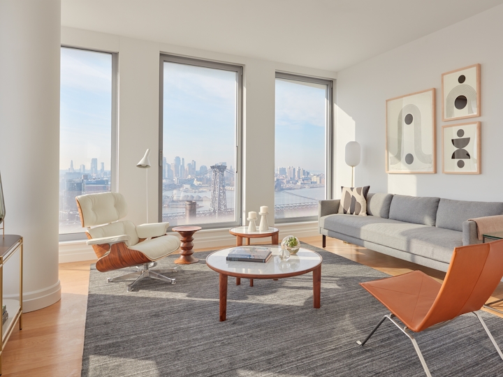 a living room filled with furniture and a large window