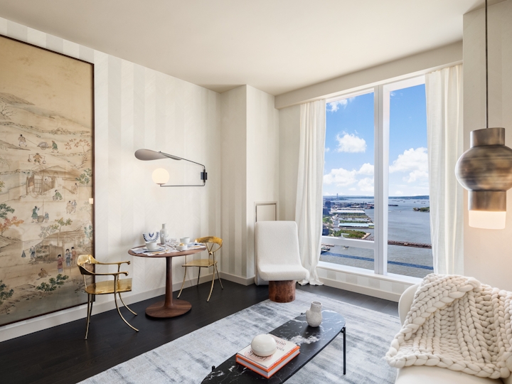 a living room filled with furniture and a large window