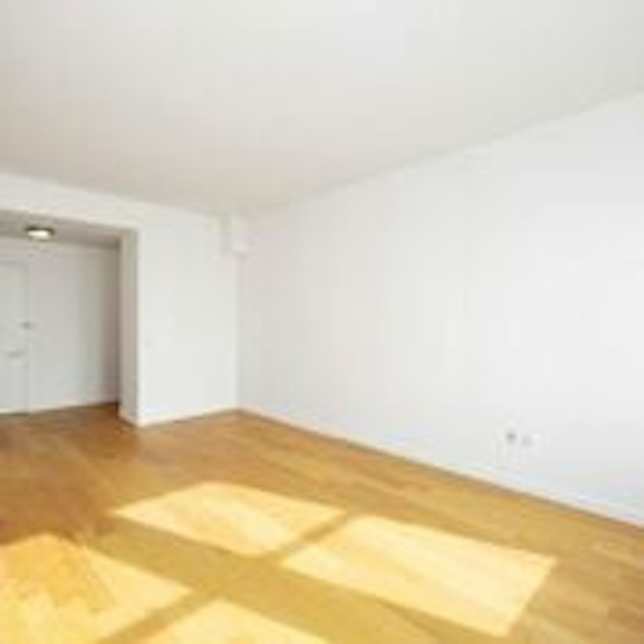 a large empty room with a wood floor