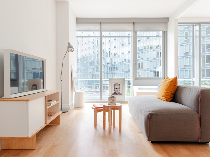 a living room filled with furniture and a large window
