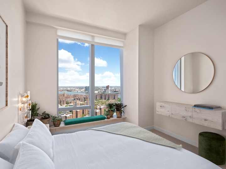 a bedroom with a bed and a large window