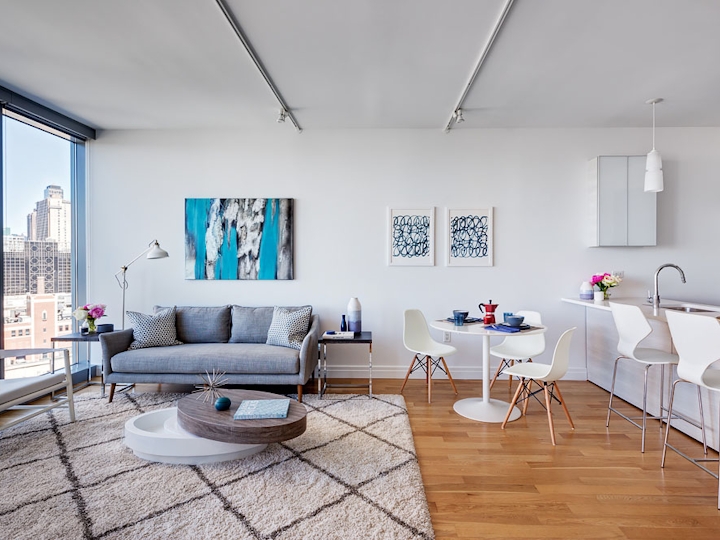 a living room filled with furniture and a large window