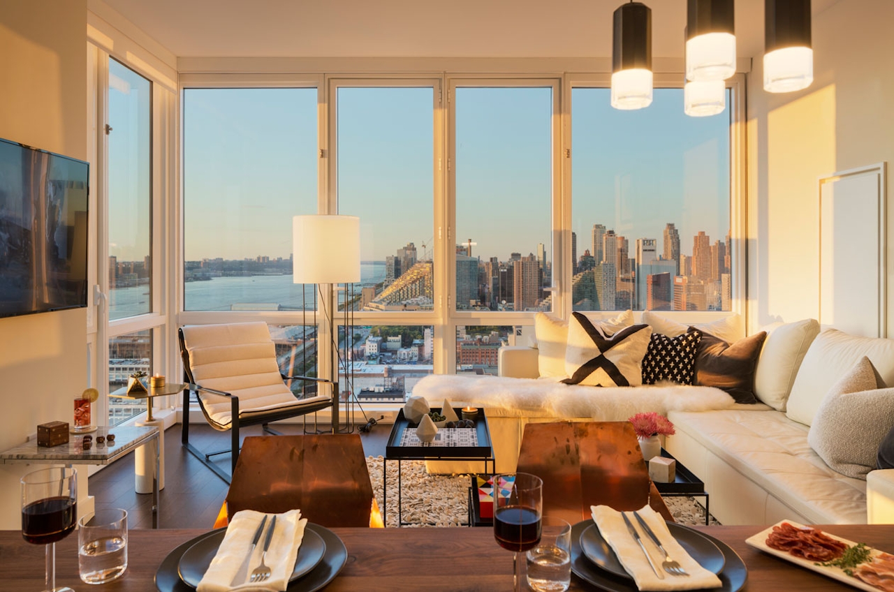 a living room filled with furniture and a large window