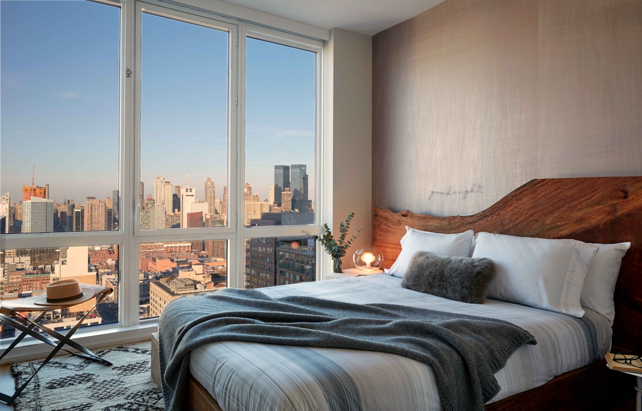 a hotel room with a bed and a large window