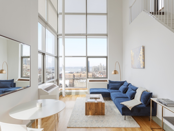 a living room filled with furniture and a large window