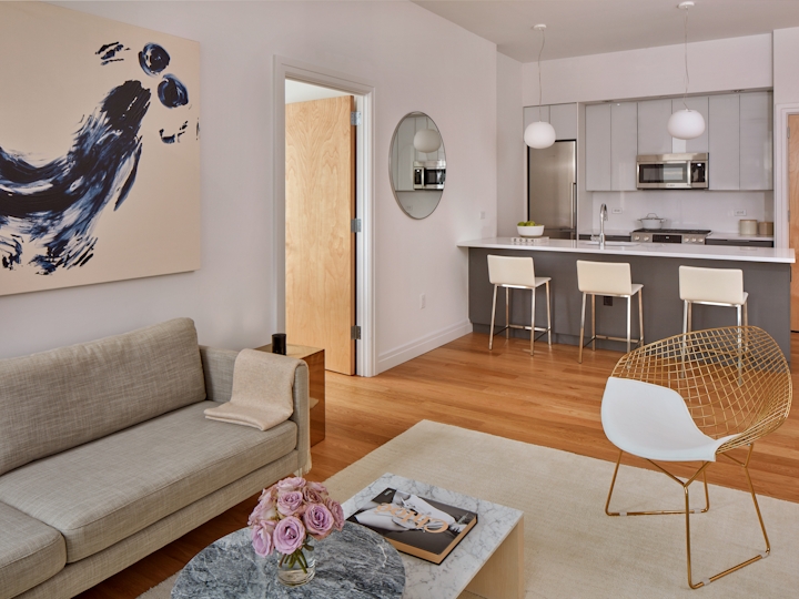 a living room filled with furniture and a mirror