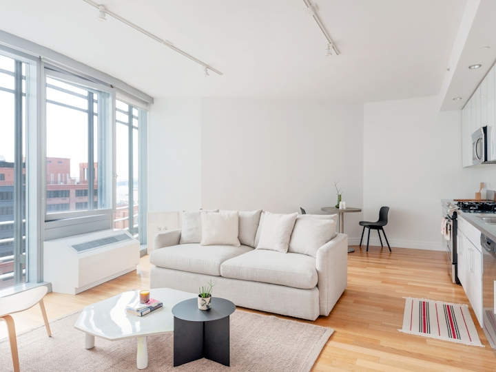 a living room filled with furniture and a large window