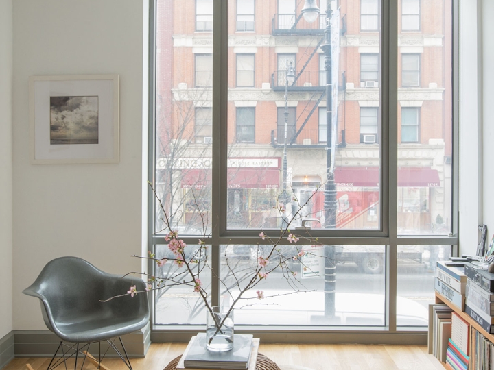 a living room filled with furniture and a large window
