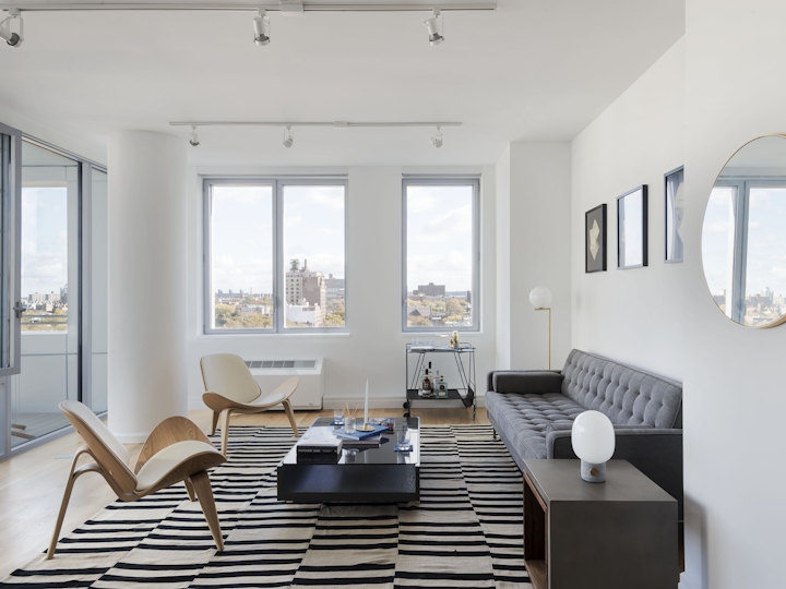 a living room filled with furniture and a large window
