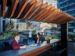 Thumbnail of The Ashland: 38G a group of people sitting at a table in front of a building