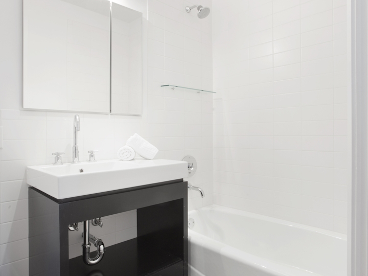 a room with a sink and a mirror
