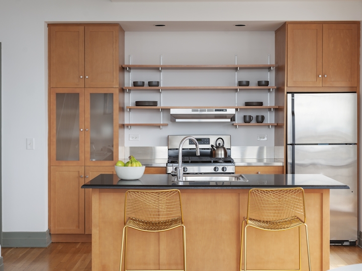 a kitchen with wooden cabinets in a room
