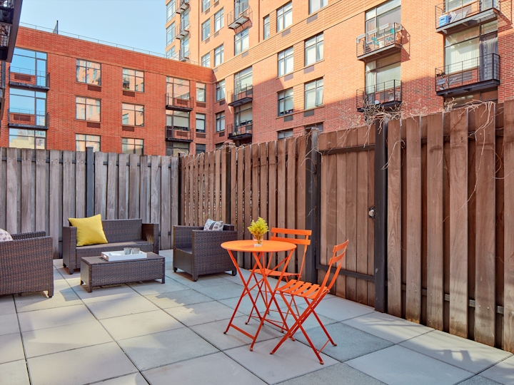 a chair sitting in front of a brick building