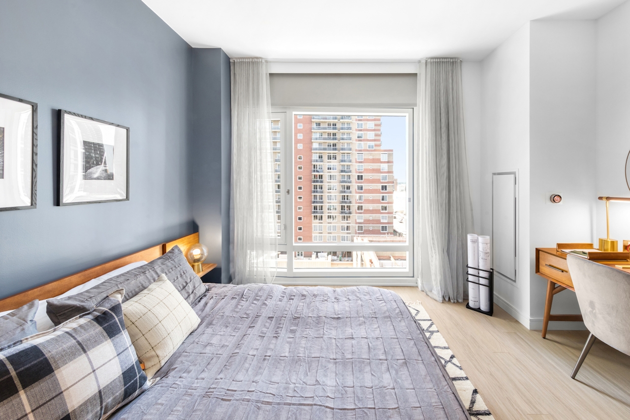 a bedroom with a large bed in a room