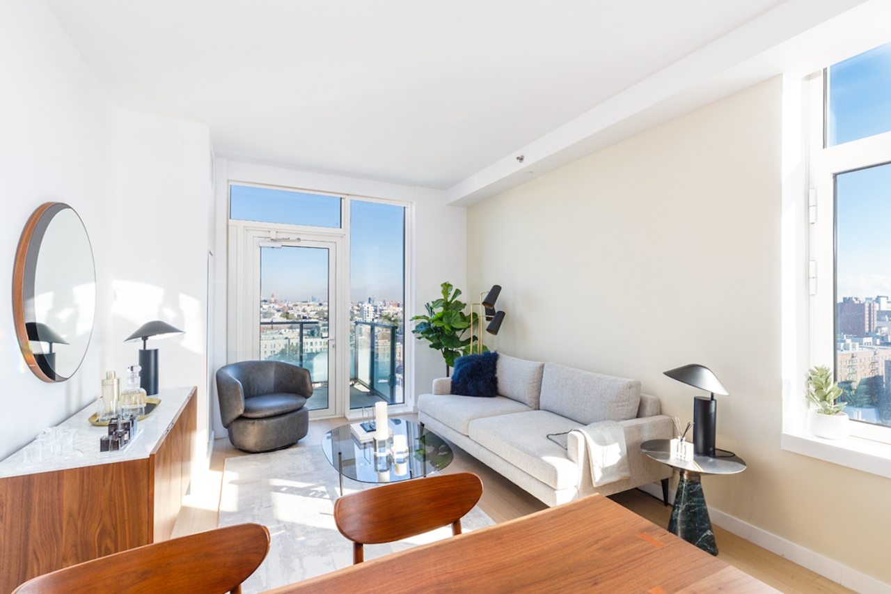 a living room filled with furniture and a large window