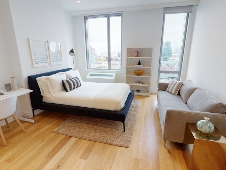 a living room filled with furniture and a large window