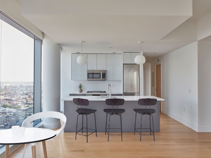 a living room filled with furniture and a large window