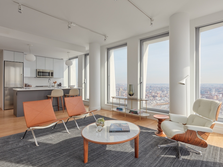a living room filled with furniture and a large window