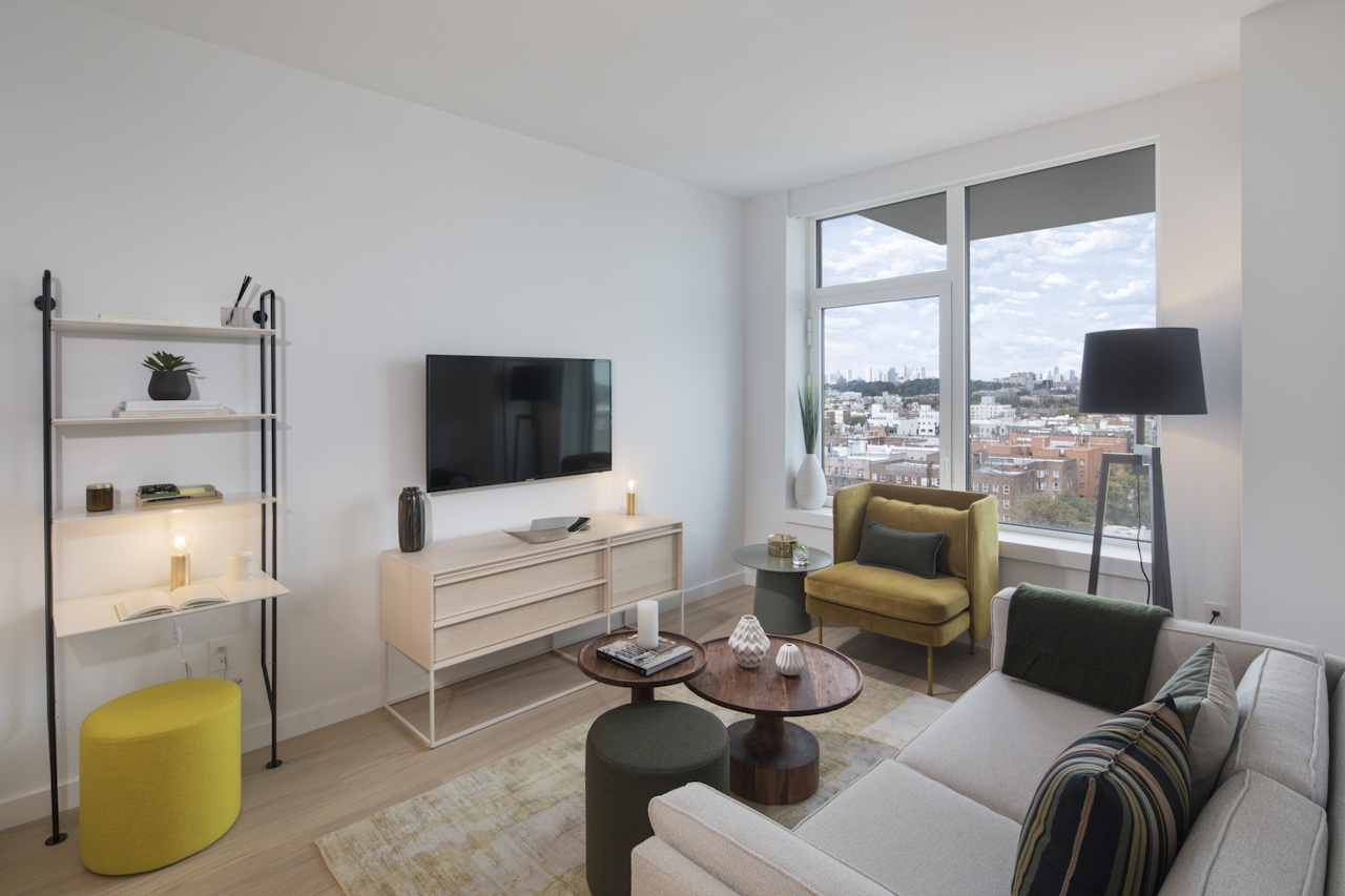 a living room filled with furniture and a large window