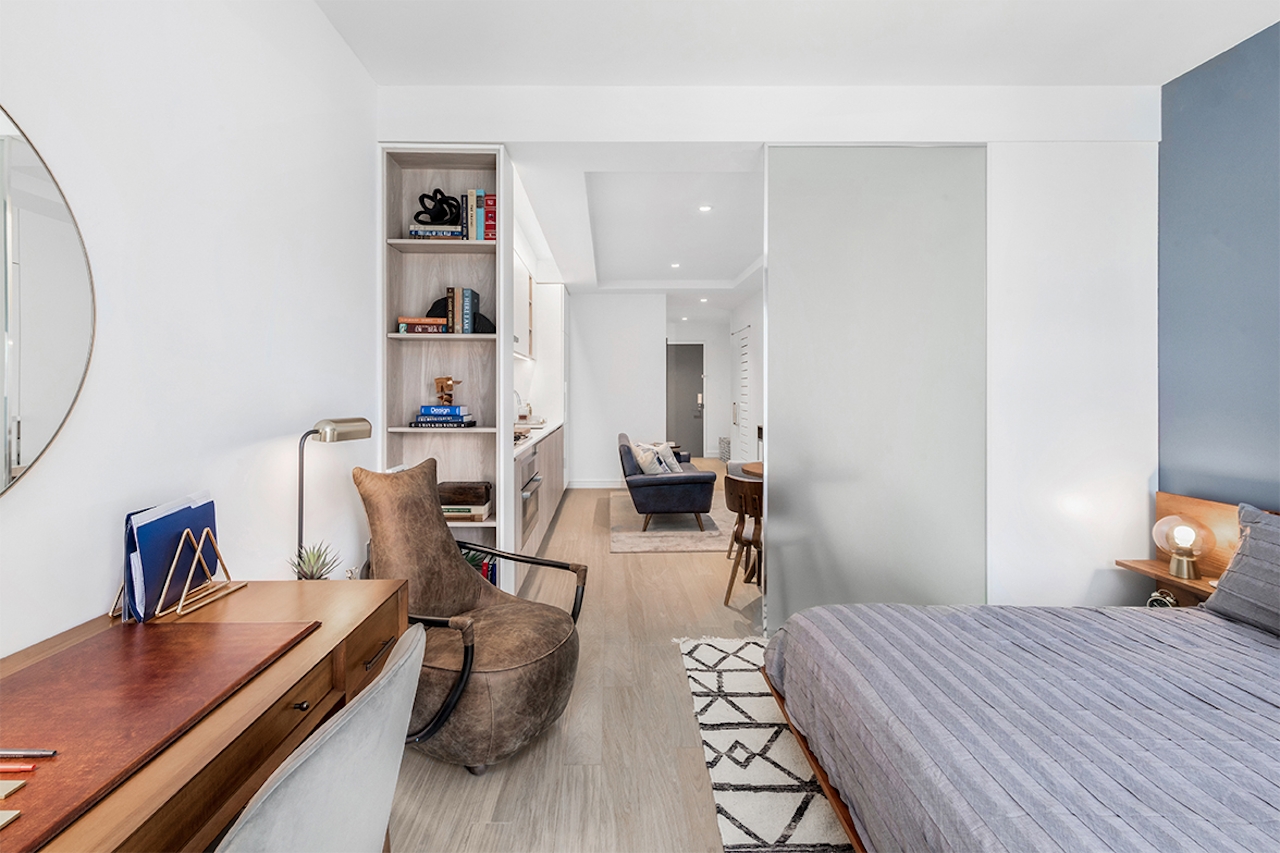 a bedroom with a cat in a living room