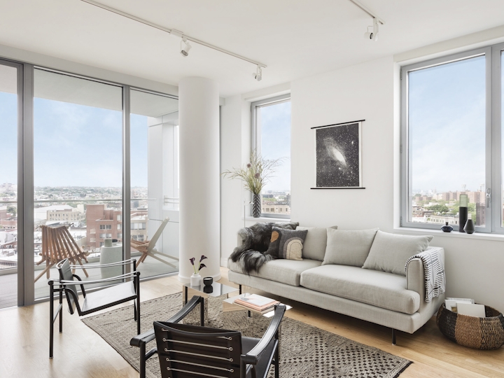 a living room filled with furniture and a large window