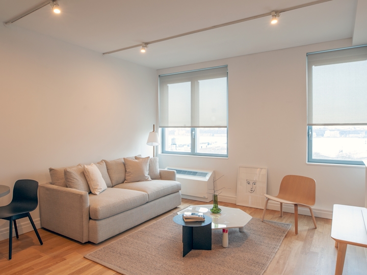 a living room filled with furniture and a large window