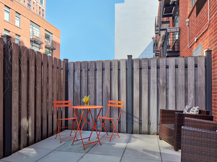 a chair sitting in front of a brick building