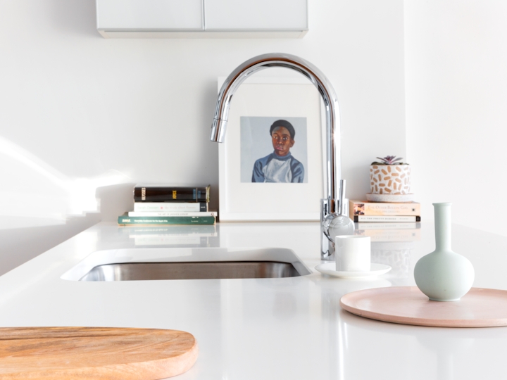 a kitchen with a sink and a mirror