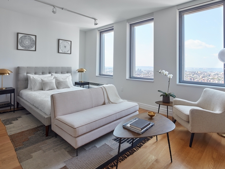 a living room filled with furniture and a large window