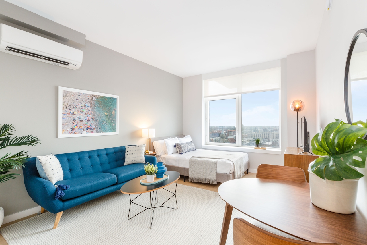 a living room filled with furniture and a large window